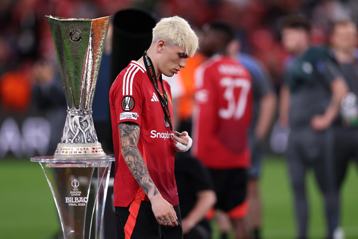 Alejandro Garnacho walking by the Europa League trophy