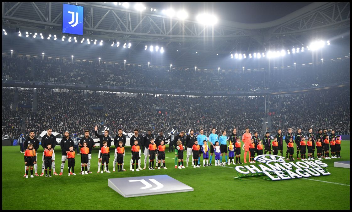 Juventus and PSV players line up ahead of kick-off.
