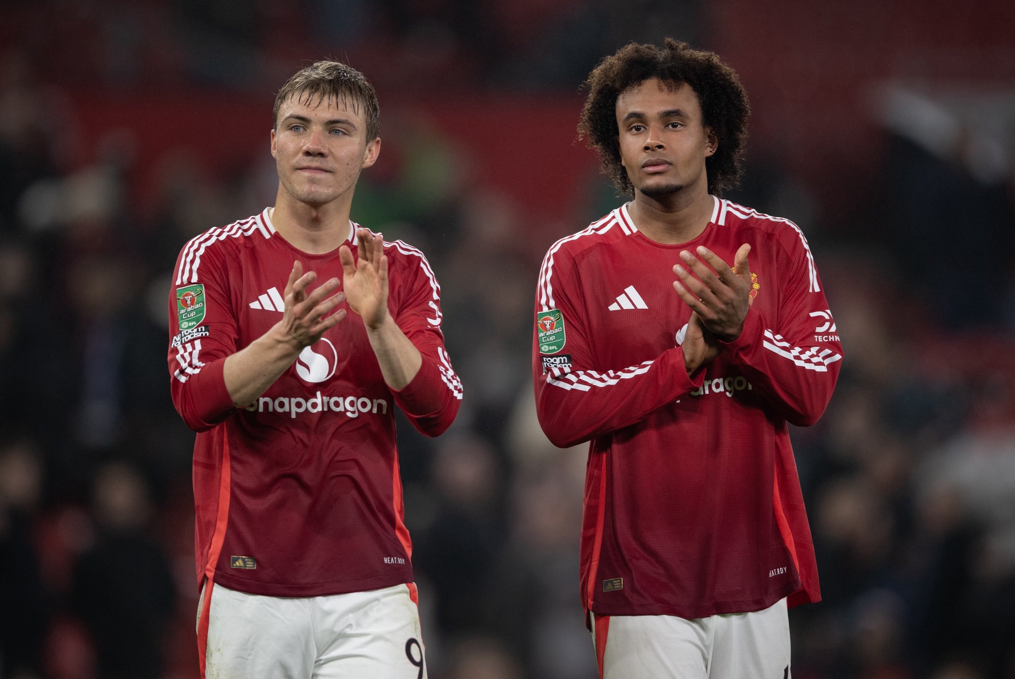 Rasmus Hojlund and Joshua Zirkzee applaud the Man United fans at full-time.