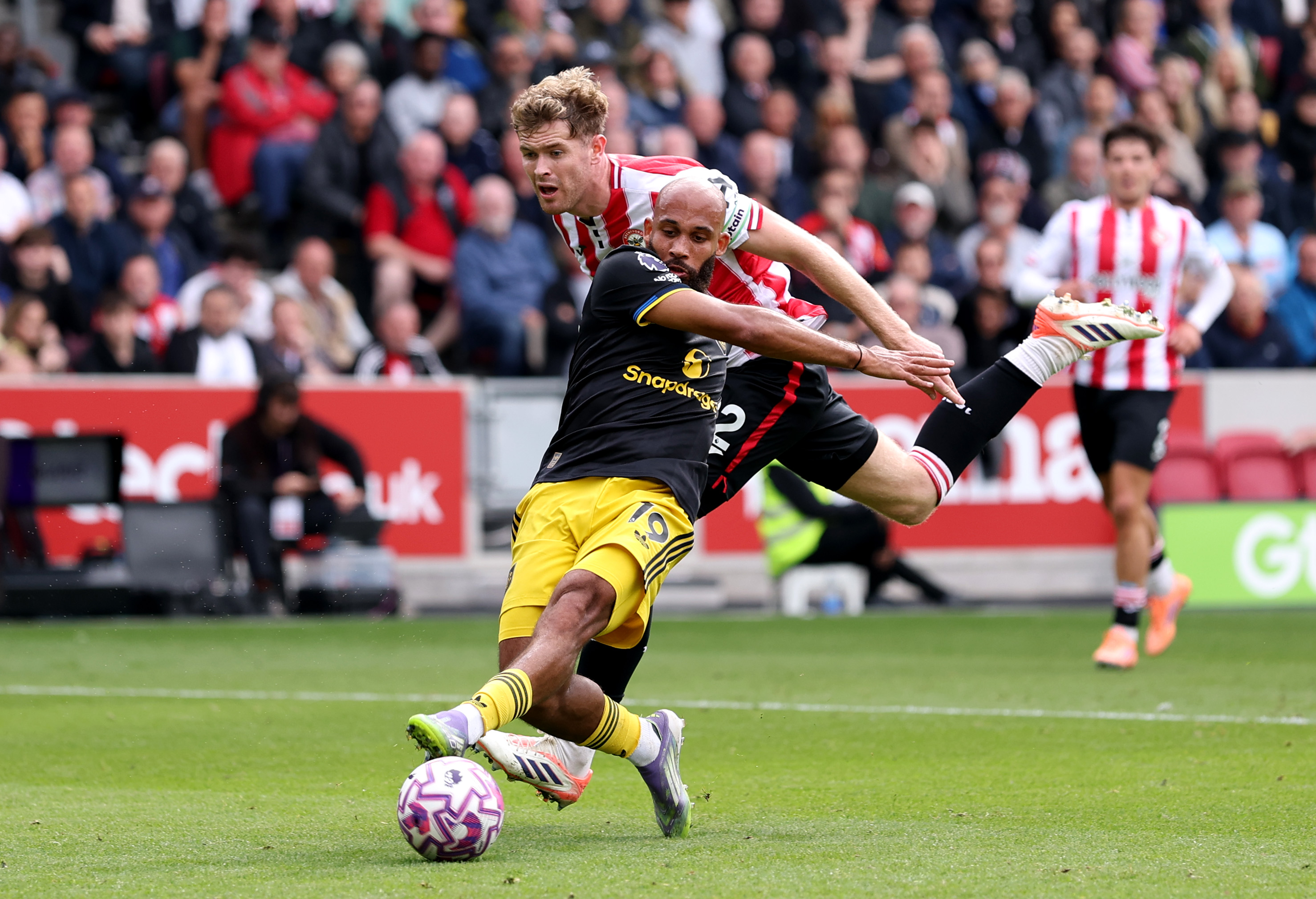 Bryan Mbeumo is pulled back by Nathan Collins in the box.