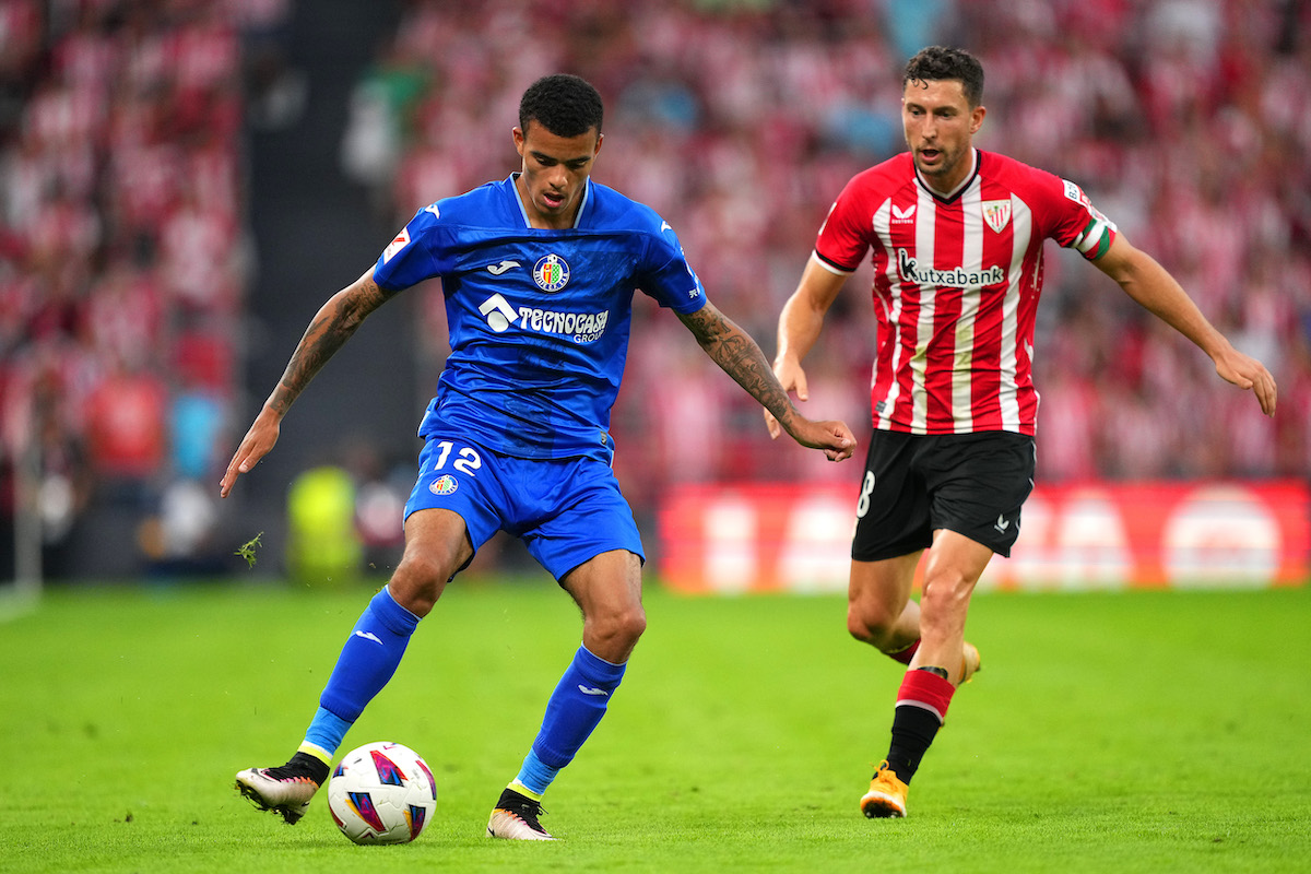 Mason Greenwood of Getafe CF controls the ball whilst under pressure from Oihan Sancet of Athletic Club
