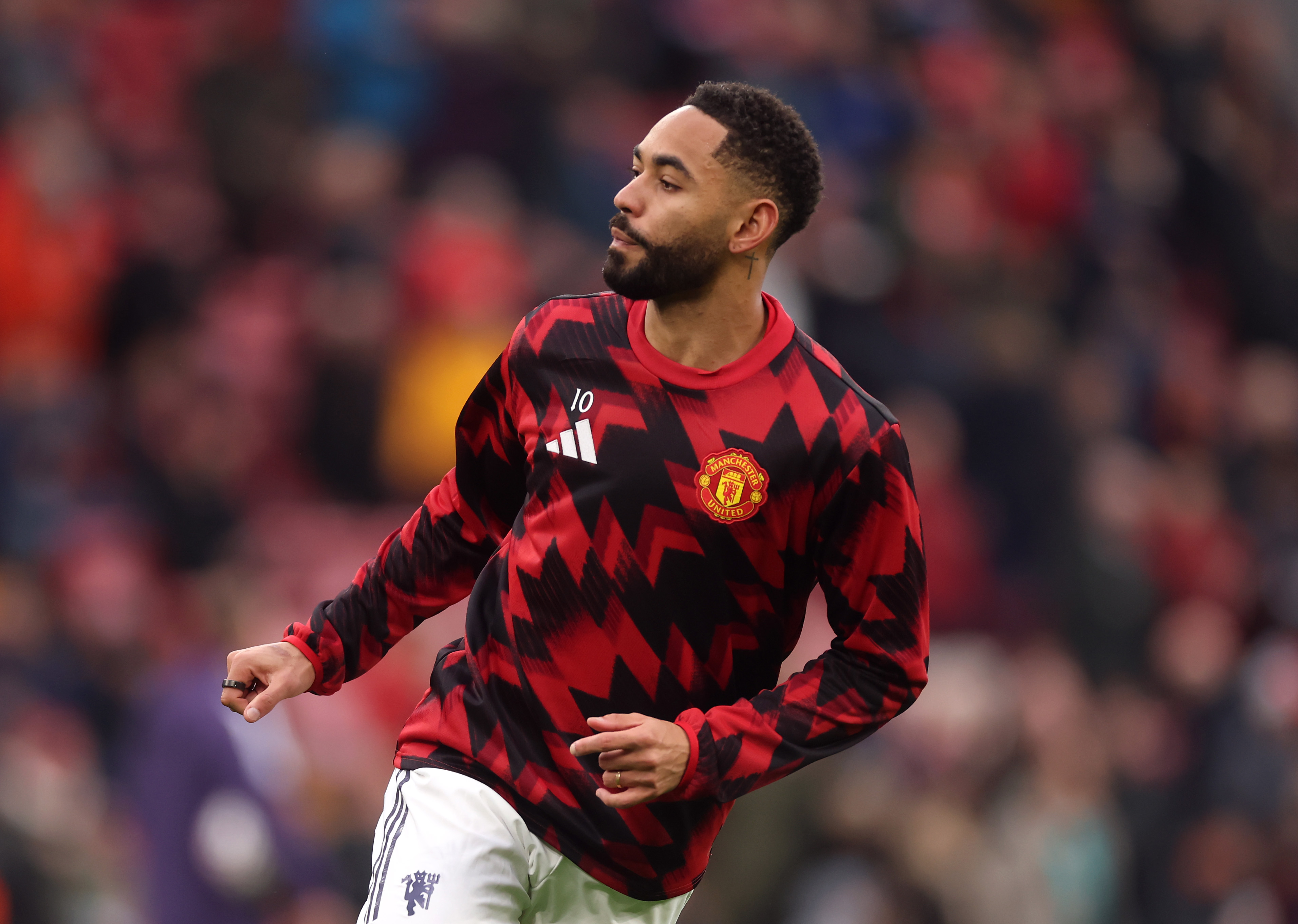 Matheus Cunha warms up before kick-off at Anfield.