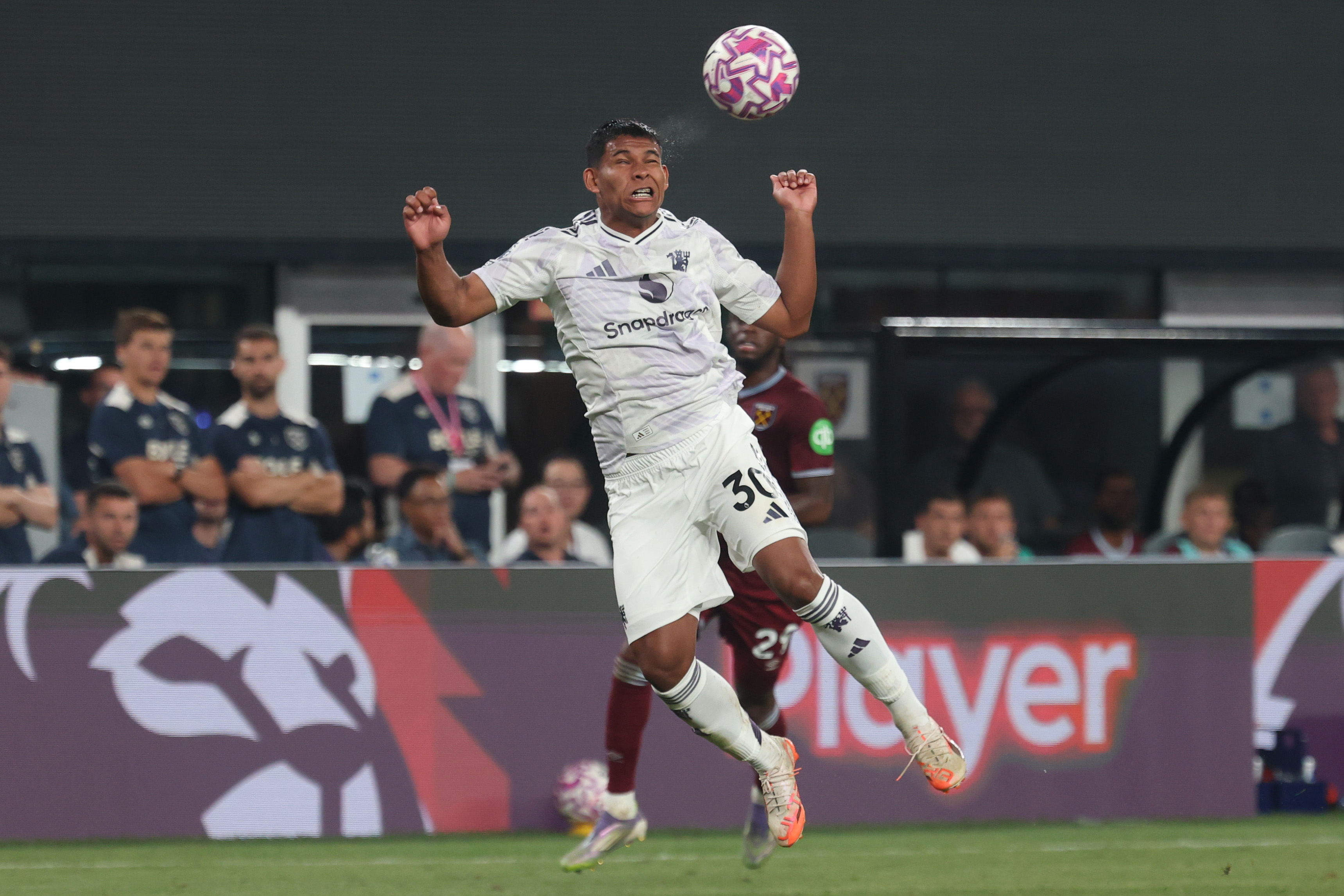 Diego Leon wins a header while under pressure from a West Ham player.
